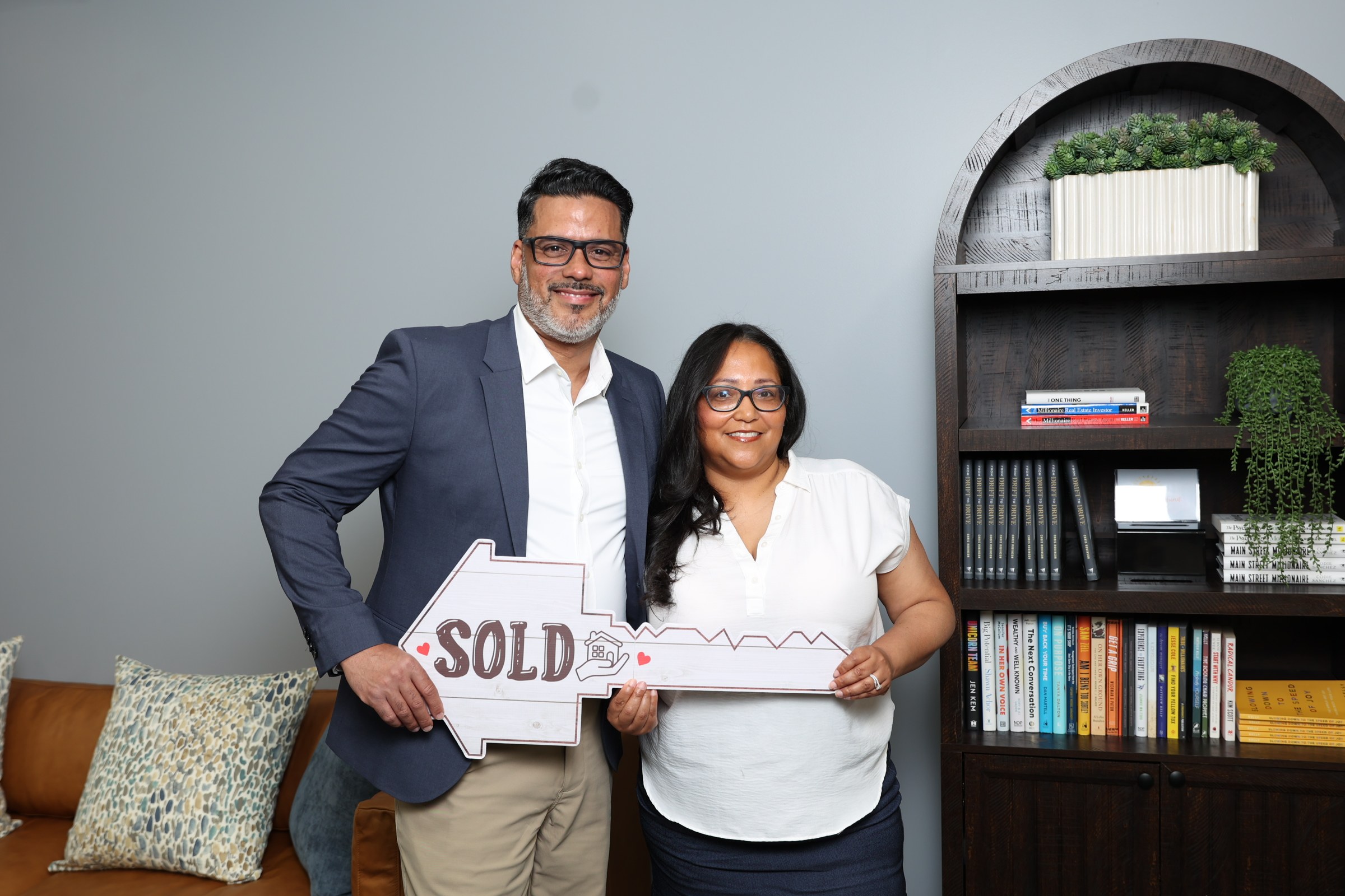 Damaris Rodriguez celebrating a sold home with a happy client